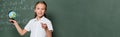 positive schoolkid with small globe pointing