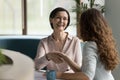 Positive senior business woman giving handshake to younger colleague Royalty Free Stock Photo