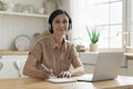 Positive senior student woman writing learning notes at laptop computer Royalty Free Stock Photo