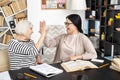 Positive senior tutor and woman completing lesson