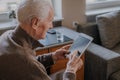 Positive Senior using Digital Tablet Royalty Free Stock Photo