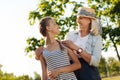 Positive senior woman enjoying time in the park with her cute granddaughter