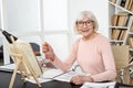 Positive senior woman studying subject