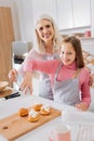 Positive skillful woman teaching her granddaughter