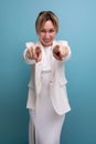 positive slim young caucasian blond lady in white jacket and dress shares ideas Royalty Free Stock Photo