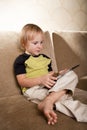 Positive small boy with tablet computer Royalty Free Stock Photo