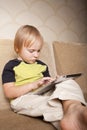 Positive small boy with tablet computer Royalty Free Stock Photo