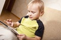 Positive small boy with tablet computer Royalty Free Stock Photo