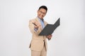 A positive Asian businessman is standing on an isolated white background with a document binder Royalty Free Stock Photo