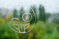 Positive smiley on a rainy autumn window Royalty Free Stock Photo