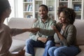 Positive smiling african american couple shaking therapist hand Royalty Free Stock Photo