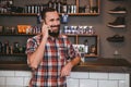 Positive smiling bearded man talking on mobile phone in barbershop Royalty Free Stock Photo