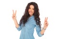 Positive smiling casual woman making victory sign Royalty Free Stock Photo