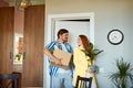 Positive smiling couple moving in new house and carrying carton boxes Royalty Free Stock Photo