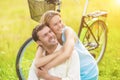 Positive Smiling Happy Couple Sitting Together Outdoors With Bike and Having Fun