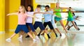 Preteen dancers practicing dance routine with female choreograph Royalty Free Stock Photo