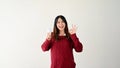 A positive Asian female is holding a light bulb and showing the Okay hand sign Royalty Free Stock Photo