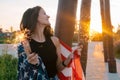positive smiling young woman with sparklers and USA flag portrait at the sunset in park Royalty Free Stock Photo