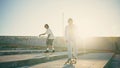 Positive sweethearts practicing skate ride sunbeams stadium. Girlfriend clapping Royalty Free Stock Photo