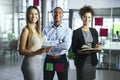 Positive teams create positive outcomes. Portrait of a group of young businesspeople working together in a modern office Royalty Free Stock Photo