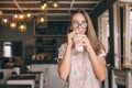 Teen girl drinking smoothie in cafe Royalty Free Stock Photo