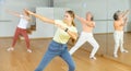 Teen girl with family doing aerobics exercises with group of people in dance center Royalty Free Stock Photo