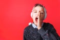 Positive teen, in Santa`s hat, shouts Royalty Free Stock Photo