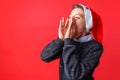 Positive teen, in Santa`s hat, shouts Royalty Free Stock Photo