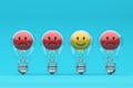 Positive thinking and standing out from the crowd with light bulbs and emoticons Royalty Free Stock Photo