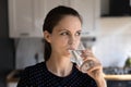 Positive thirsty young woman drinking fresh clean pure water