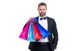 positive tuxedo man with shopping bag isolated on white background. tuxedo man after shopping.