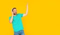 positive unshaven young man in headphones on yellow background, modern education