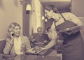 Positive waiter bringing order to happy charming mature female