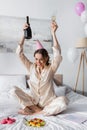Positive woman with champagne sitting near