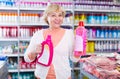 Positive woman choosing household chemical goods Royalty Free Stock Photo