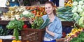 Woman is choosing vagetables with basket