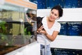 Positive woman with dog in her arms choosing aquarium fish at pet shop Royalty Free Stock Photo