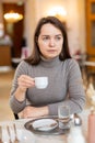 Positive woman enjoying cup of delicious espresso in cafe Royalty Free Stock Photo