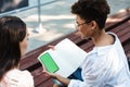 Positive woman with her friend doing homework Royalty Free Stock Photo