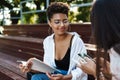 Positive woman with her friend doing homework Royalty Free Stock Photo