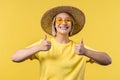 Positive woman makes hand sign like, thumbs up gesture. Happy girl, correct perfect choice, great deal, yellow Royalty Free Stock Photo