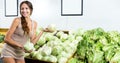 Positive woman shopping fresh green lettuce