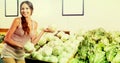 Positive woman shopping fresh green lettuce