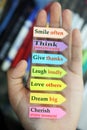 Positive words in hand. Todays goals list. Morning inspirational words - Smile often. Think positively. Give thanks. Laugh loudly Royalty Free Stock Photo