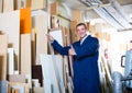 positive workman standing with plywood pieces Royalty Free Stock Photo