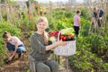 Woman posing in garden with harvested vegetables Royalty Free Stock Photo