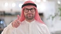 Positive young arabic man doing thumbs up