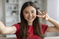 Positive Young Asian Woman Taking Selfie While Relaxing At Home Royalty Free Stock Photo