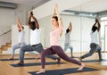 Woman doing Crescent High Lunge Pose with arms in prayer above head Royalty Free Stock Photo