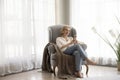 Carefree woman relaxing at home with smartphone Royalty Free Stock Photo